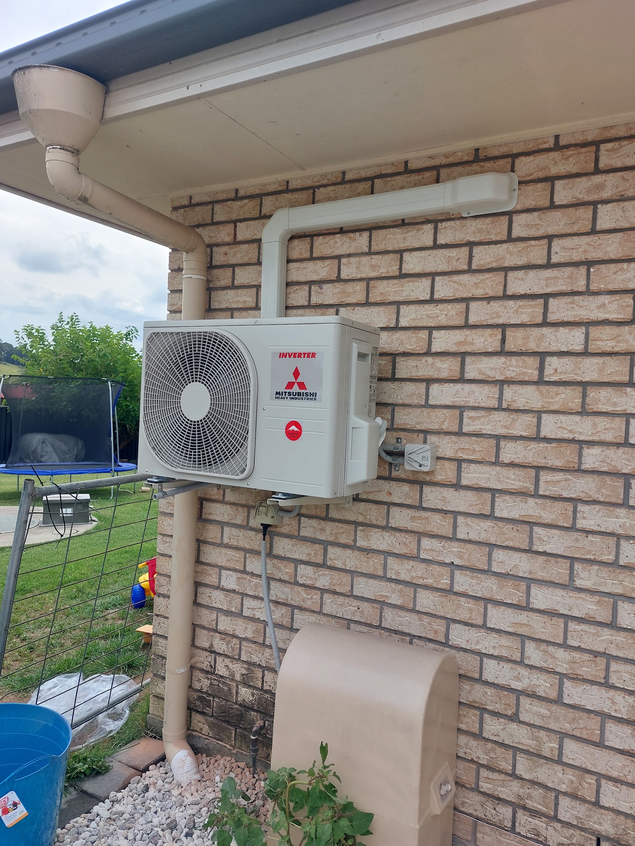 Split system outdoor unit installed with a neat duct run