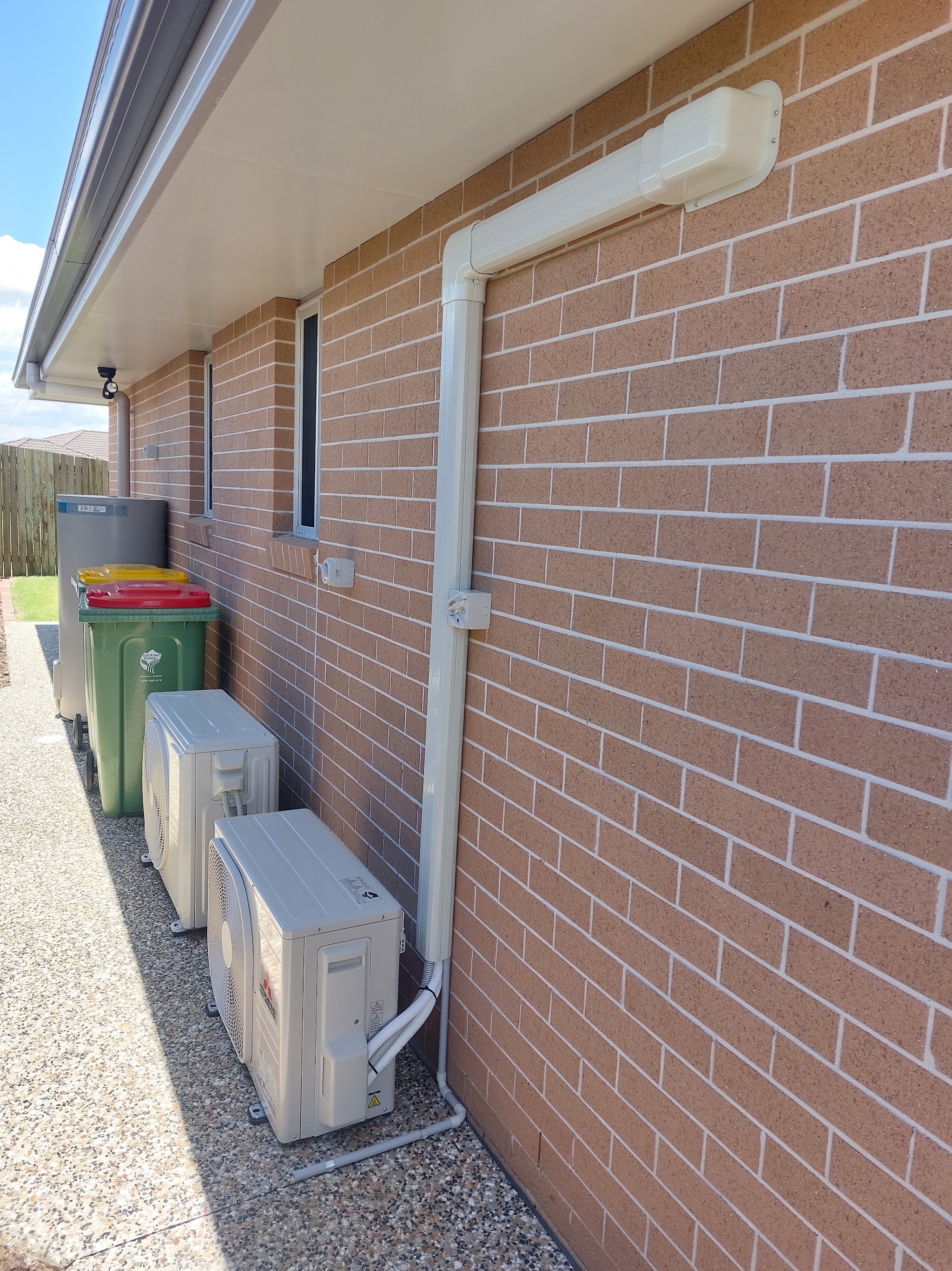 Two split system units with ducting run tidily along the wall