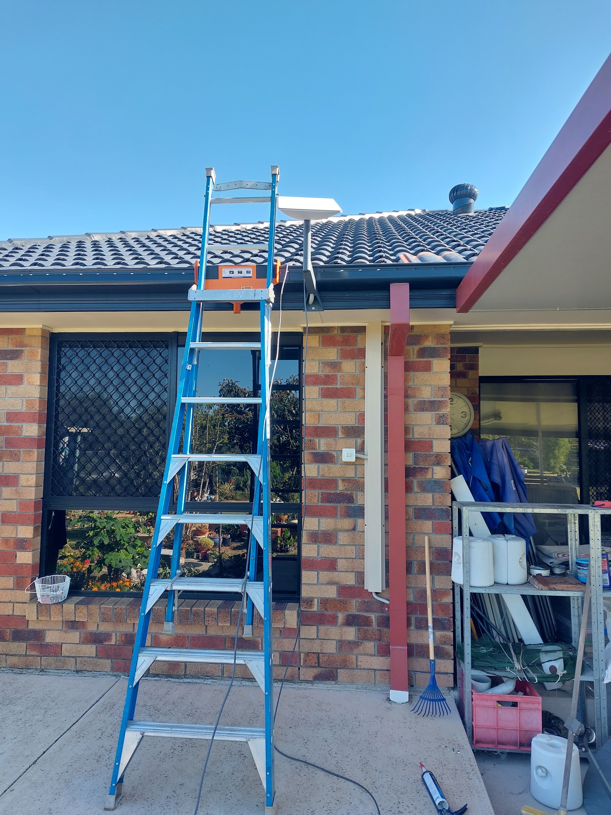A dish mounted and aligned on a tiled roof